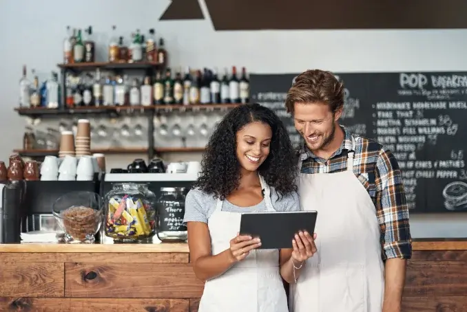 Photo 1 — owner at the counter or on a laptop